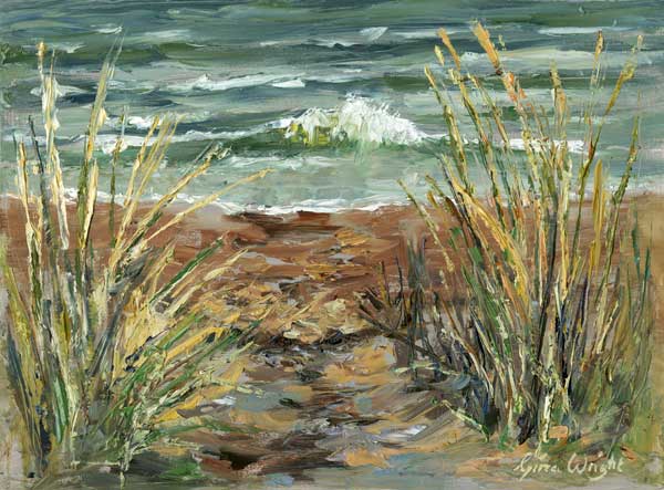 View through beach tress to a wave coming on to the beach