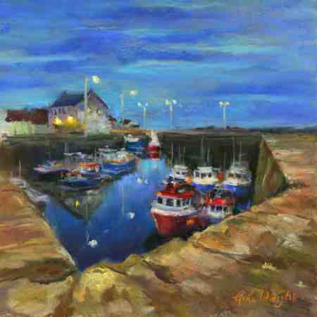 Blue sky of dusk reflected in the waters of the harbour around the moored boats