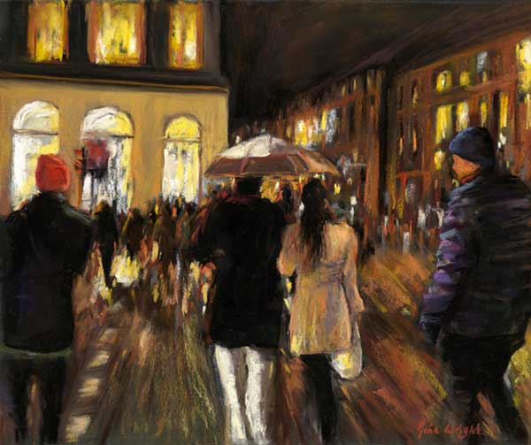 People walking in the rain towards lighted buildings