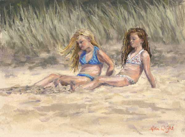 Two girls lazing on the beach