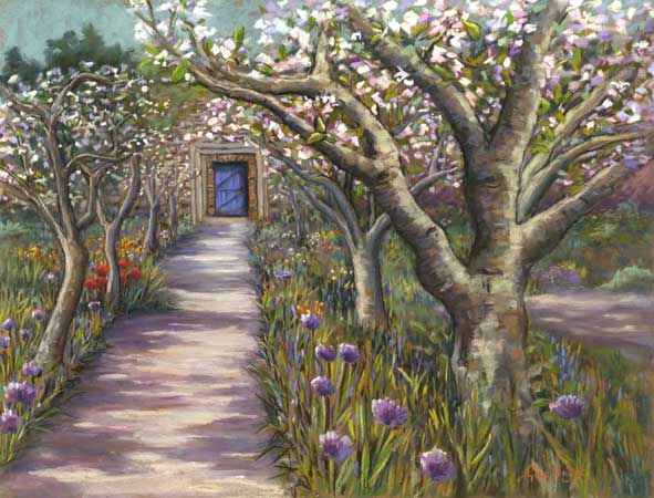 A gravel path between fruit trees in blosom leading to a door in a wall
