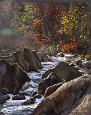 Waterfall on river running between trees in autumn colours