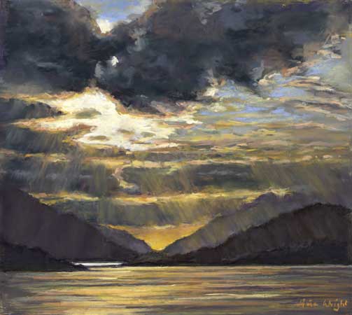 The sun setting over the loch of Glencoe surrounded by mountains