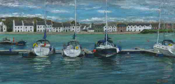 Yachts moors at the marina with houses in the background